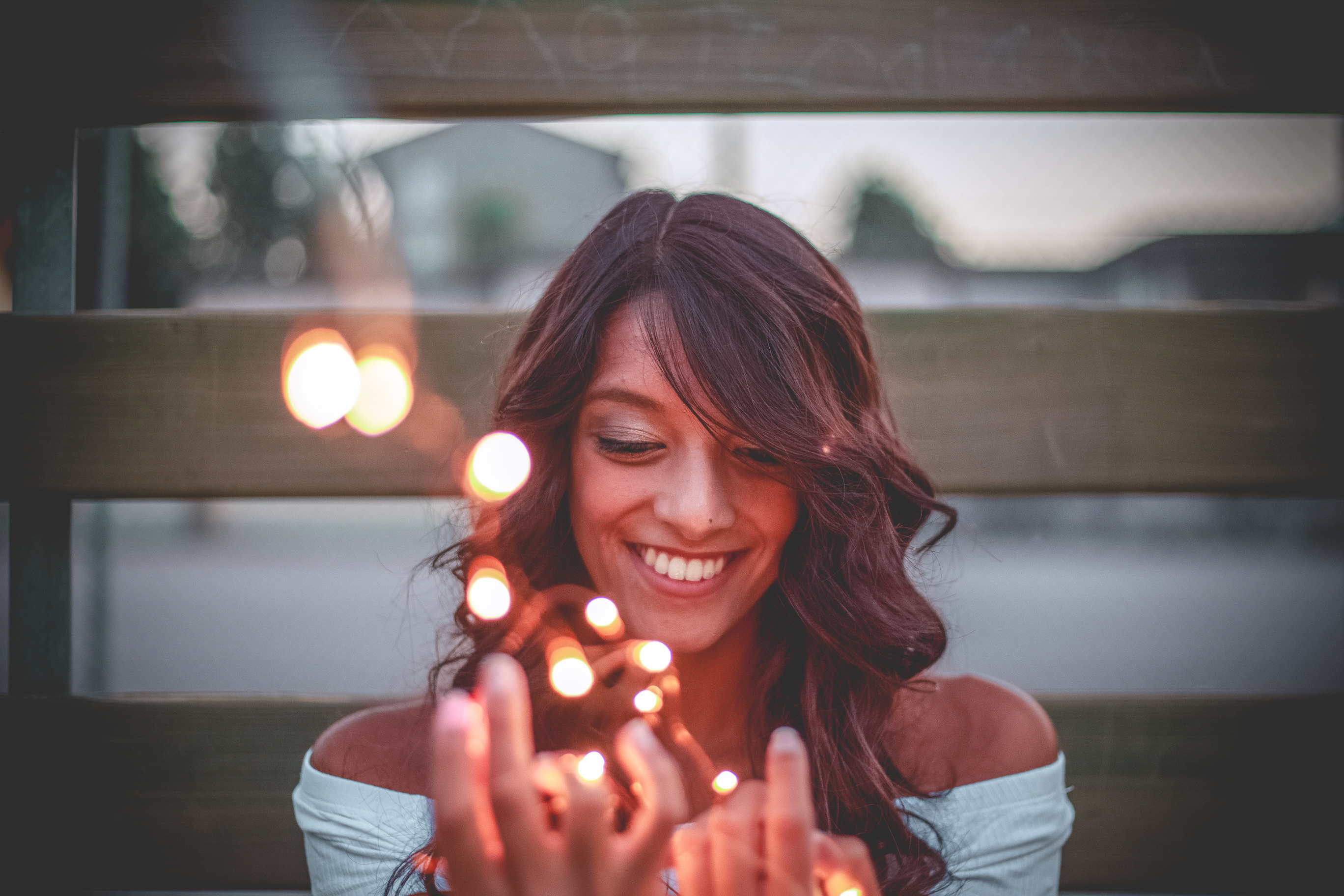 Selective Focus Photography Of Smiling Woman Holding String Lights